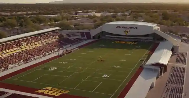 A collegiate athletic facility with various sports equipment and arenas in the background displaying ASU Athletics.