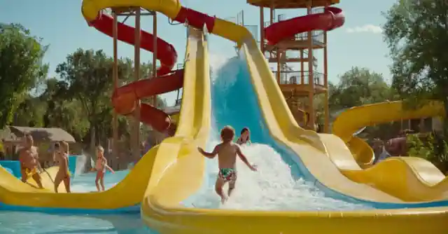 A family enjoying various water slides in an aquatic park with childrens areas highlighted.