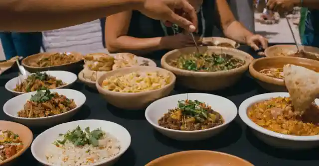 A person tasting various homemade dishes at an indigenous food festival in Queen Creek.