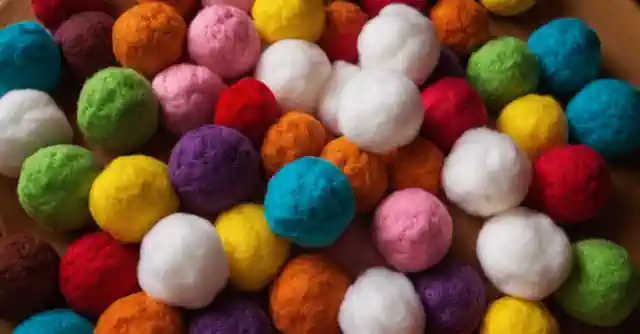 Children engaged with various texturized cotton balls for sensory exploration.
