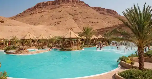 A vibrant image capturing the scenic beauty and swimming options at the desert resort water park in Chand]).