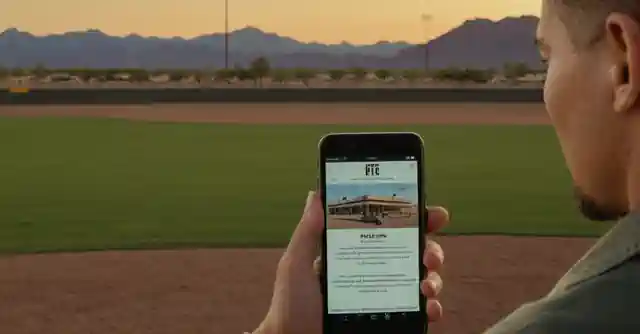 Person reading about the history and facilities at Falcon Field in Mesa, Phoenix on their phone or tablet.