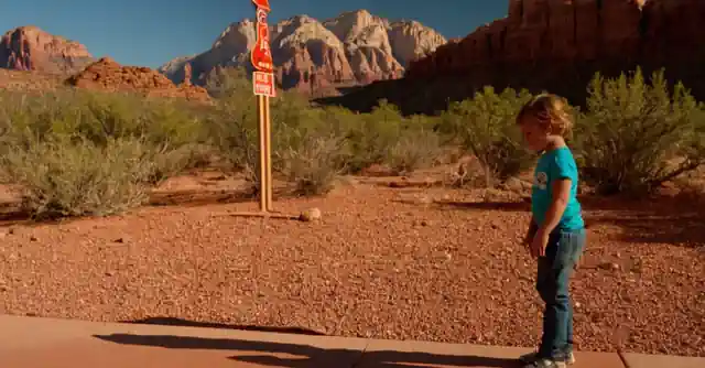 A child enjoying outdoor activities in Red Rock Country, AZ with age sign displayed on the side.