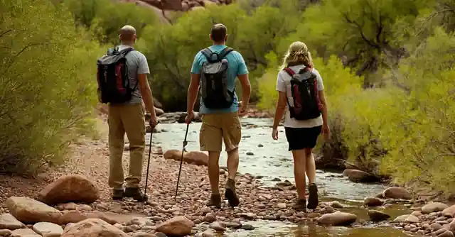 Family hiking and enjoying the scenery with safety tools at a creek in Arizona.