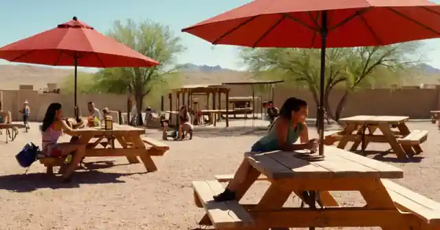 A family enjoying picnic tables and recreational facilities at Descubra Family Fun Adventure Park in the Gateway Park of El Mirage, Arizona.