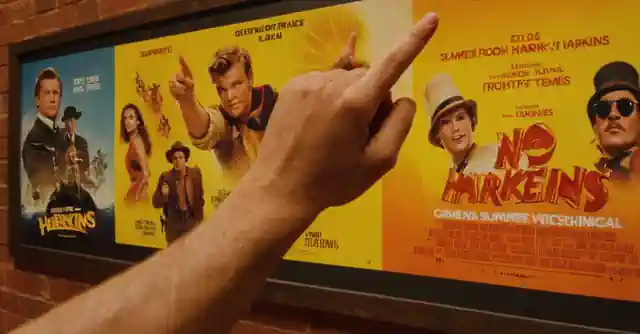 Hand pointing at a poster featuring various summer Harkins Movie series themes.