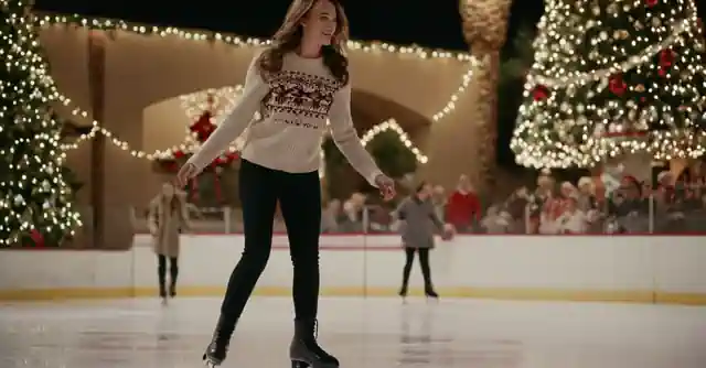 Person skating with joy on an ice rink in Phoenix, surrounded by Christmas decorations.