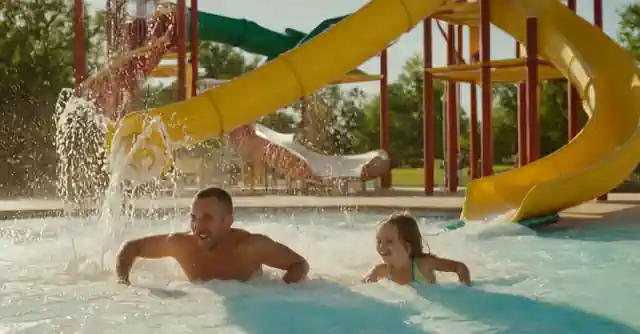 A family enjoying water slides at the splash park in Phoenixs Kroc Center.