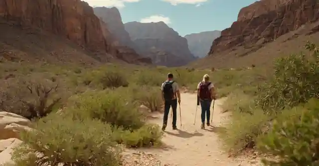 Tourists exploring the trails in Little Canyon Park with mountains and desert plants.