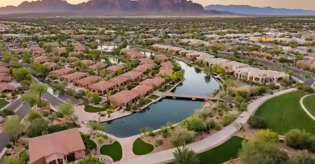 Graphic highlighting the unique communities within Mesa, Arizona. This graphic could depict key landmarks or icons representing different exclusive communities in Meza, such as Park of Tortolita washes (representing luxury neighborhoods), Eastmark Community Center (depicting family-oriented areas) and the Town Lake Hike & Bike Trail System (for active lifestyle regions). This infographic should be laid out in an easy to understand way, each icon labelled appropri curosly and perhaps accompanied by brief descriptions. The overall design should promote a sense of variety and inclusivity reflecting Mesas diverse residential areas.
