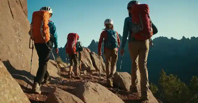 A group of children climbing gear in front on the Pinnacle Peak trail.