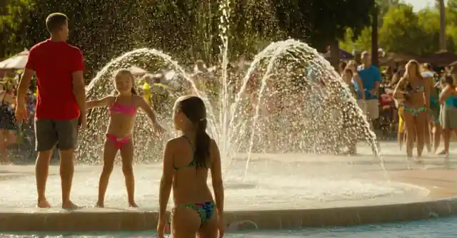 Spectators enjoying the water features at the interactive splash pad in Rio Vista.