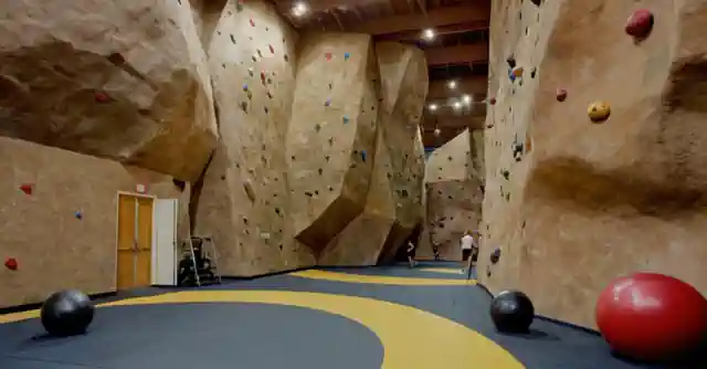 An inviting gymnasium with climbing walls and boulders for various skill levels in Scottsdale, AZ.